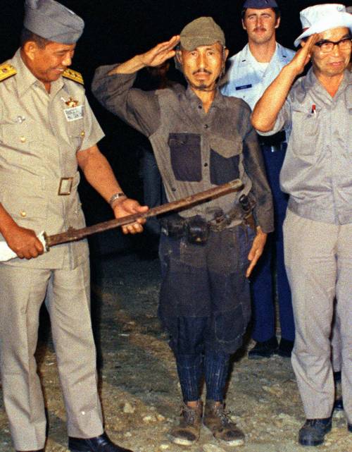 Hiroo Onoda in una foto nel 1974, nell'atto di consegnare le armi
