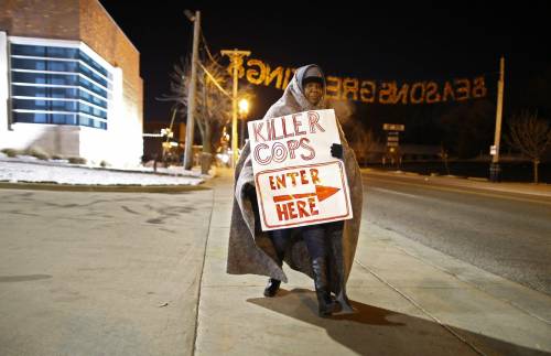 Una manifestante fuori dal dipartimento di polizia di Ferguson, nel Missouri