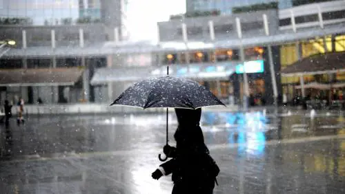La prima neve scende su piazza Gae Aulenti a Milano