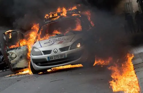 Parigi, molotov contro la polizia: auto incendiate, agenti feriti