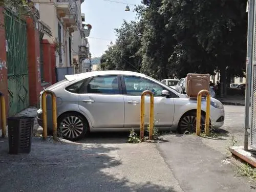 Ostruisce con l’auto lo scivolo dei disabili: i residenti gli piazzano un bidone sul cofano