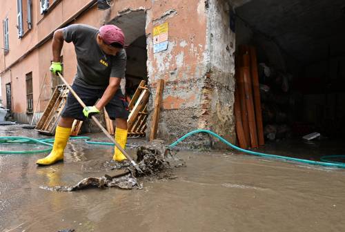 Operai al lavoro per liberare scantinati dall'acqua, dopo il nubifragio a Genova