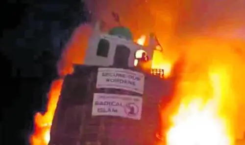 Un protestante brucia il simbolo di una moschea