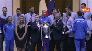 Draghi solleva la Coppa di Euro2020 a Palazzo Chigi con i giocatori in posa per la foto di gruppo