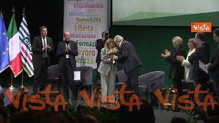 Standing ovation per Meloni all'assemblea della Cisl, Luigi Sbarra regala dei fiori alla premier