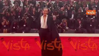 Venezia 82, look sofisticato per Noomi Rapace sul red carpet in pantaloni e soprabito con strascico