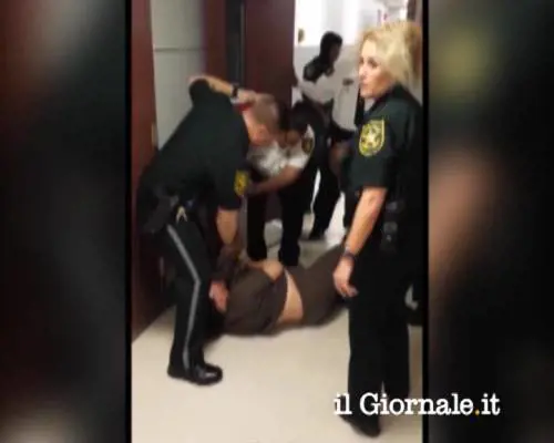 Poliziotto trascina una malata di mente per i piedi
