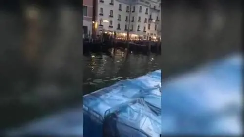 Venezia, due uomini nudi sul pontile del Canal Grande