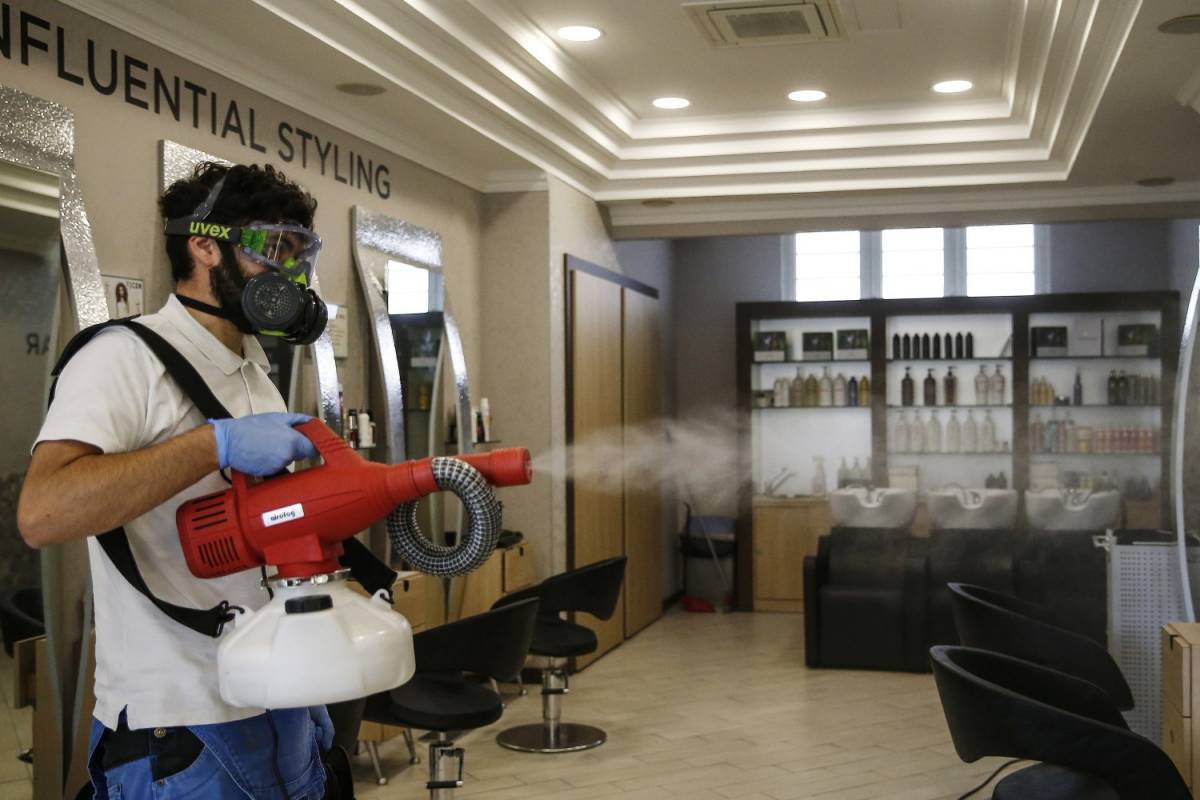 Sanificazione in un negozio di parrucchiere a Roma. (La Presse)
